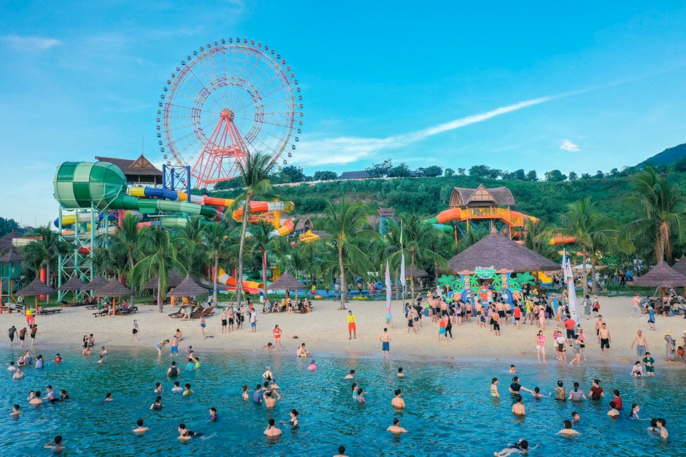 Travelers can swim in calm waters or relax on the soft sand under palm trees